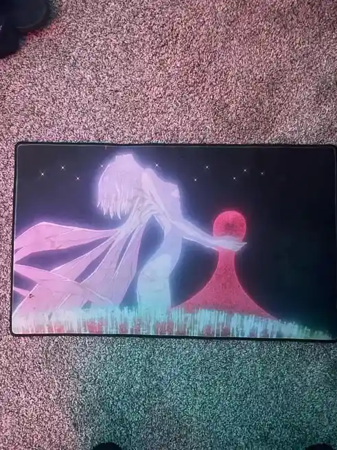 A rectangular mousepad with an anime-style illustration of a glowing, translucent figure with long hair and flowing robes…