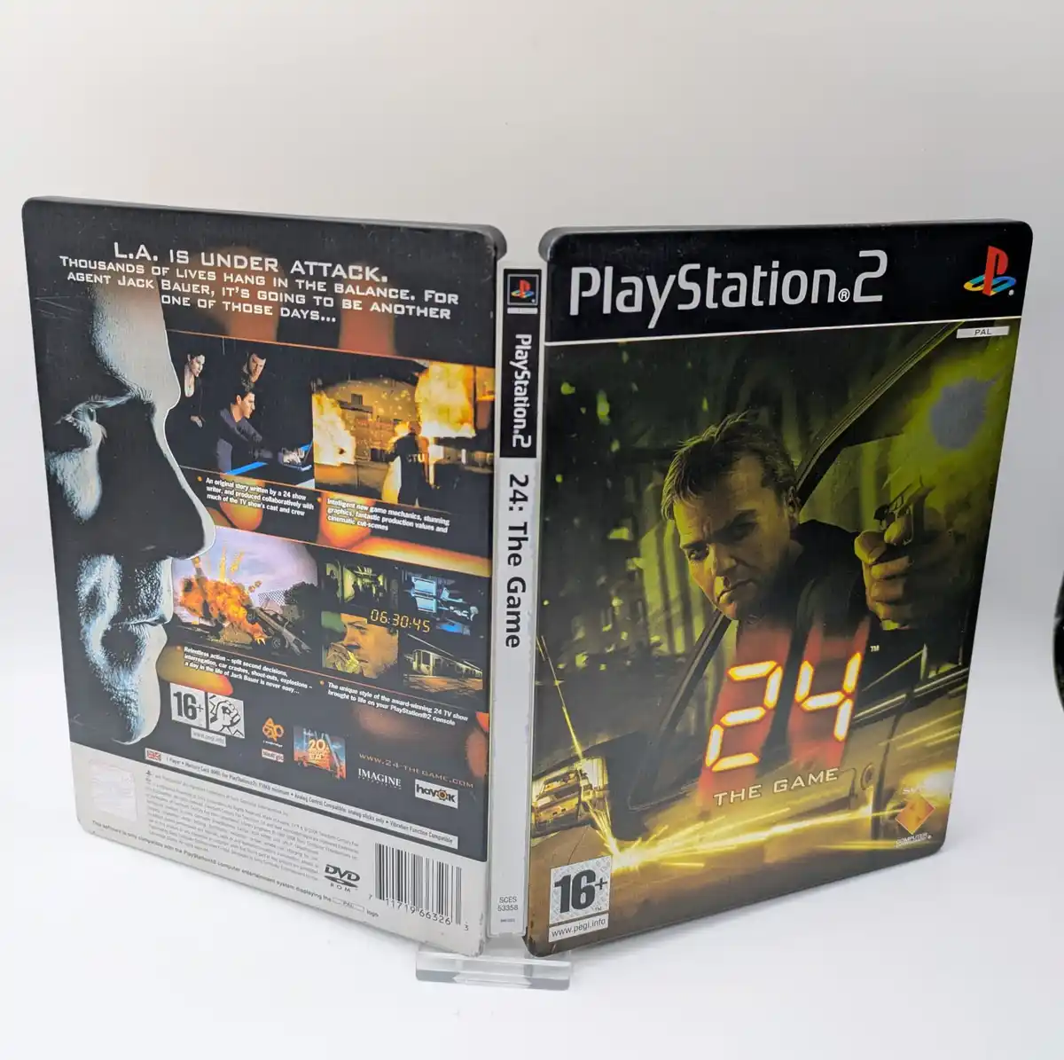 A physical PlayStation 2 game case for '24: The Game' is shown standing upright, displaying both the front cover and back…