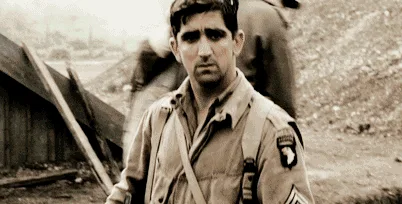 A sepia-toned image sequence shows a man in a military uniform progressively saluting with increasing intensity, culminating…