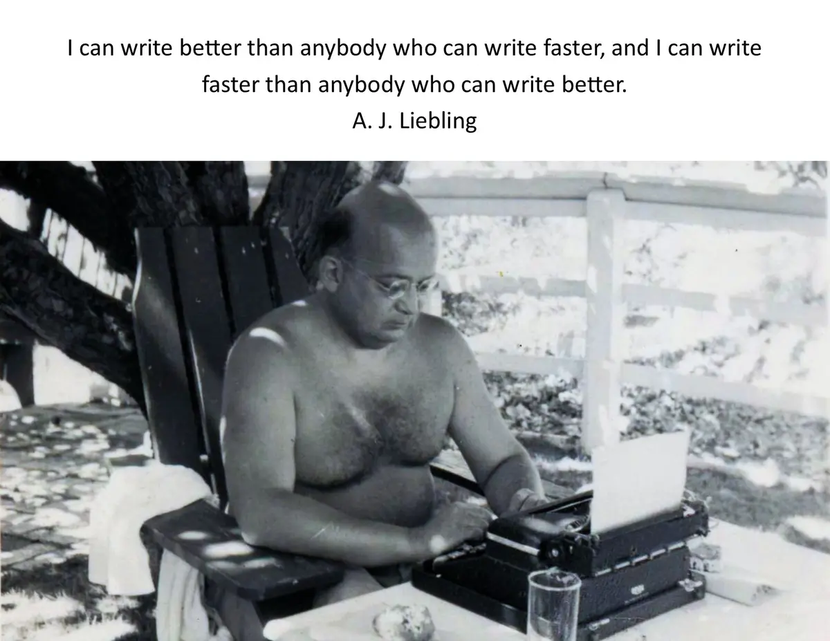 A black-and-white photo shows a shirtless man with glasses sitting in a wooden chair outdoors, typing on a manual…