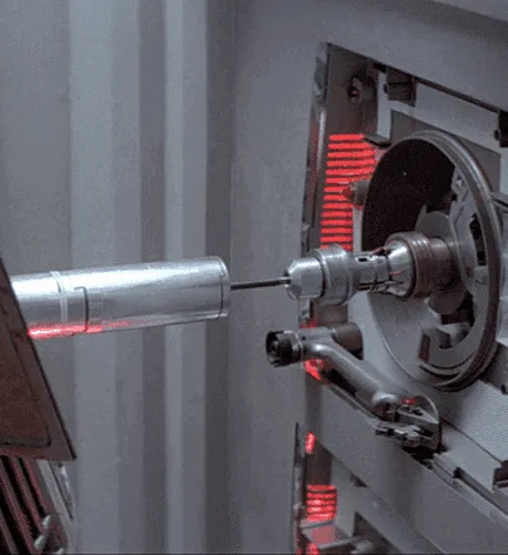 A six-panel grid shows a mechanical device with a rotating cylindrical component and red indicator lights. In each panel…