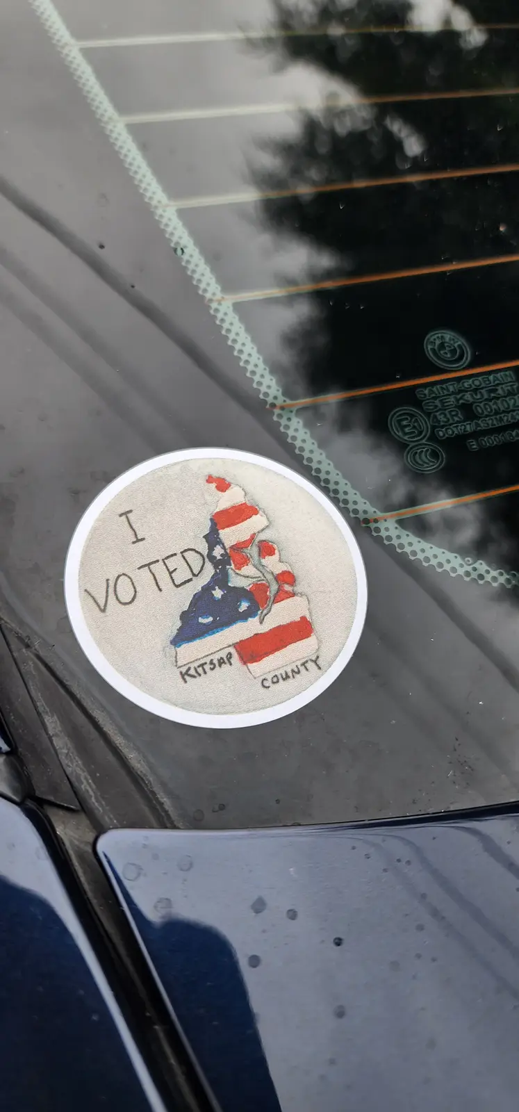 A circular 'I VOTED' sticker from Kitsap County, featuring a patriotic design with an American flag motif, is affixed to the…