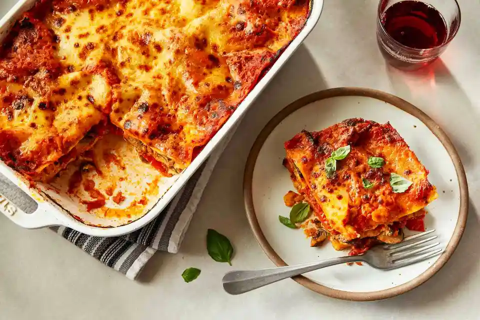 Indulge in a Three-Cheese Lasagna Loaded with Roasted Red Peppers and Mushrooms