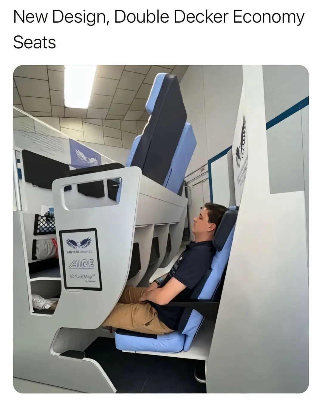 A man sits in a cramped airplane seat that is part of a 'double decker' design, with another seat stacked directly above…