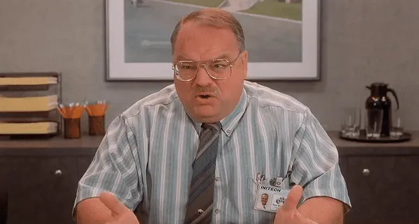 The image shows six panels of the same man, a middle-aged white man with glasses and a striped shirt, seated at a desk in an…