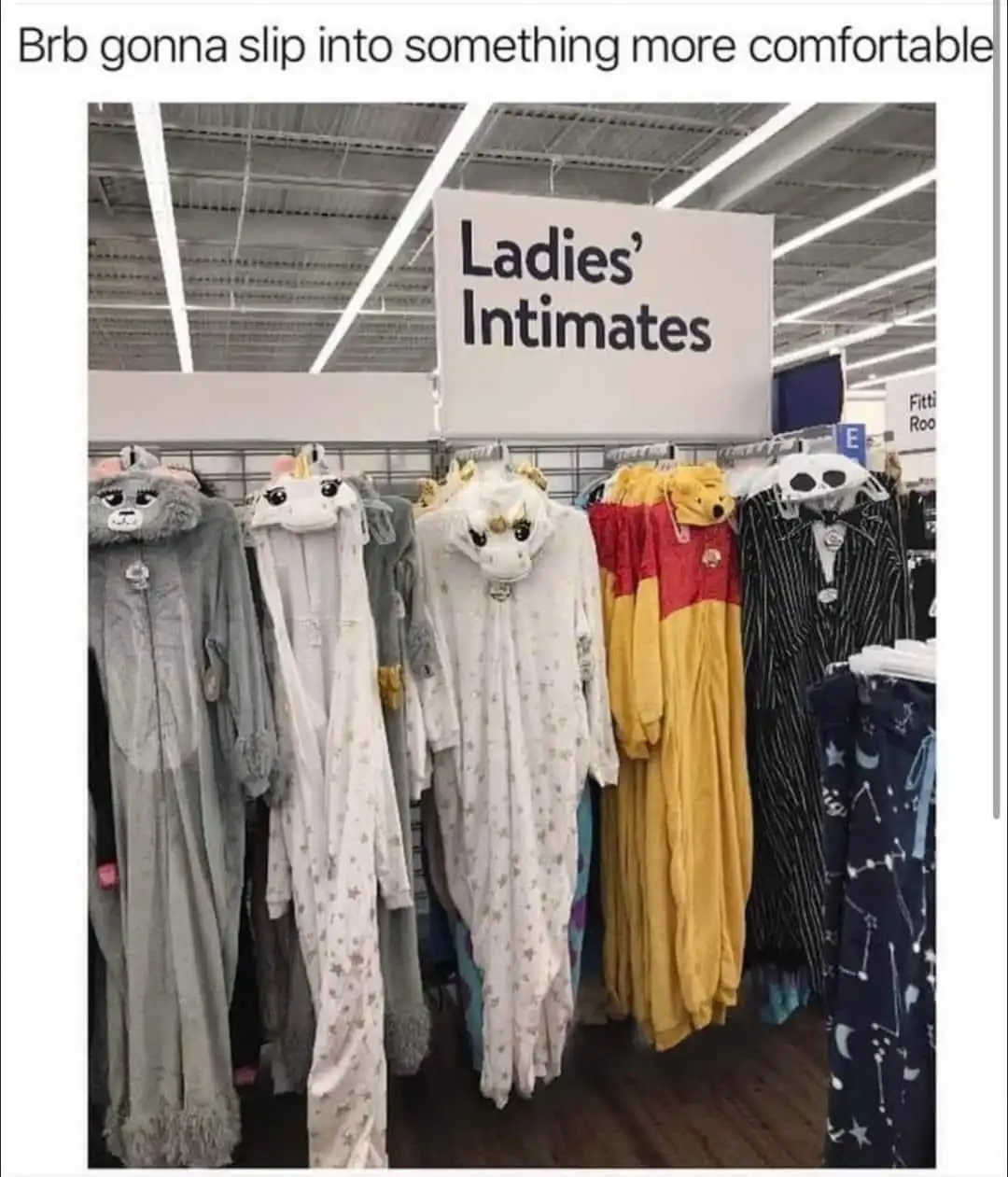 A photo of a retail store aisle labeled 'Ladies' Intimates' showing racks of plush, cartoon-themed onesies and pajamas…