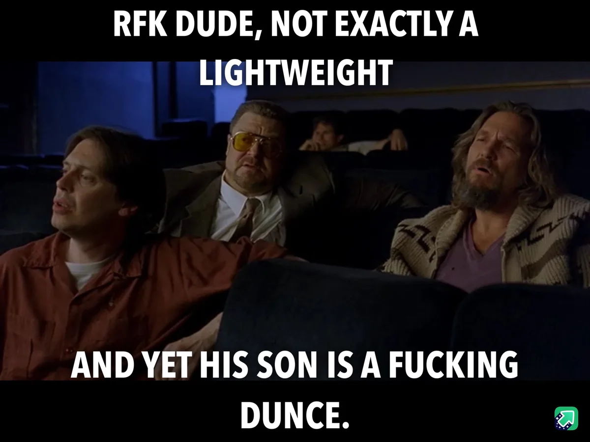 Three men sit in a dark theater, looking bored or unimpressed. The man on the left wears a red shirt, the center man wears a…