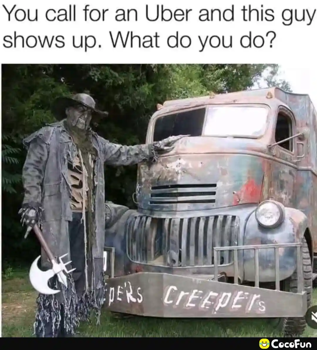 A person dressed as a scary, skeletal figure with a wide grin, wearing a hat and holding an axe, stands next to a rusty, old…
