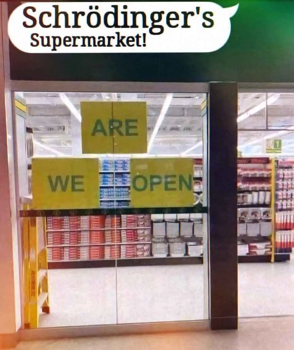A photo of a supermarket entrance with glass doors. Three yellow signs are taped to the glass, reading 'ARE', 'WE', and…