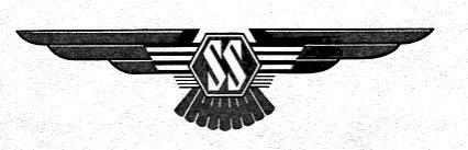 A black-and-white image shows a stylized emblem with wings spread out on either side of a central hexagon containing the…
