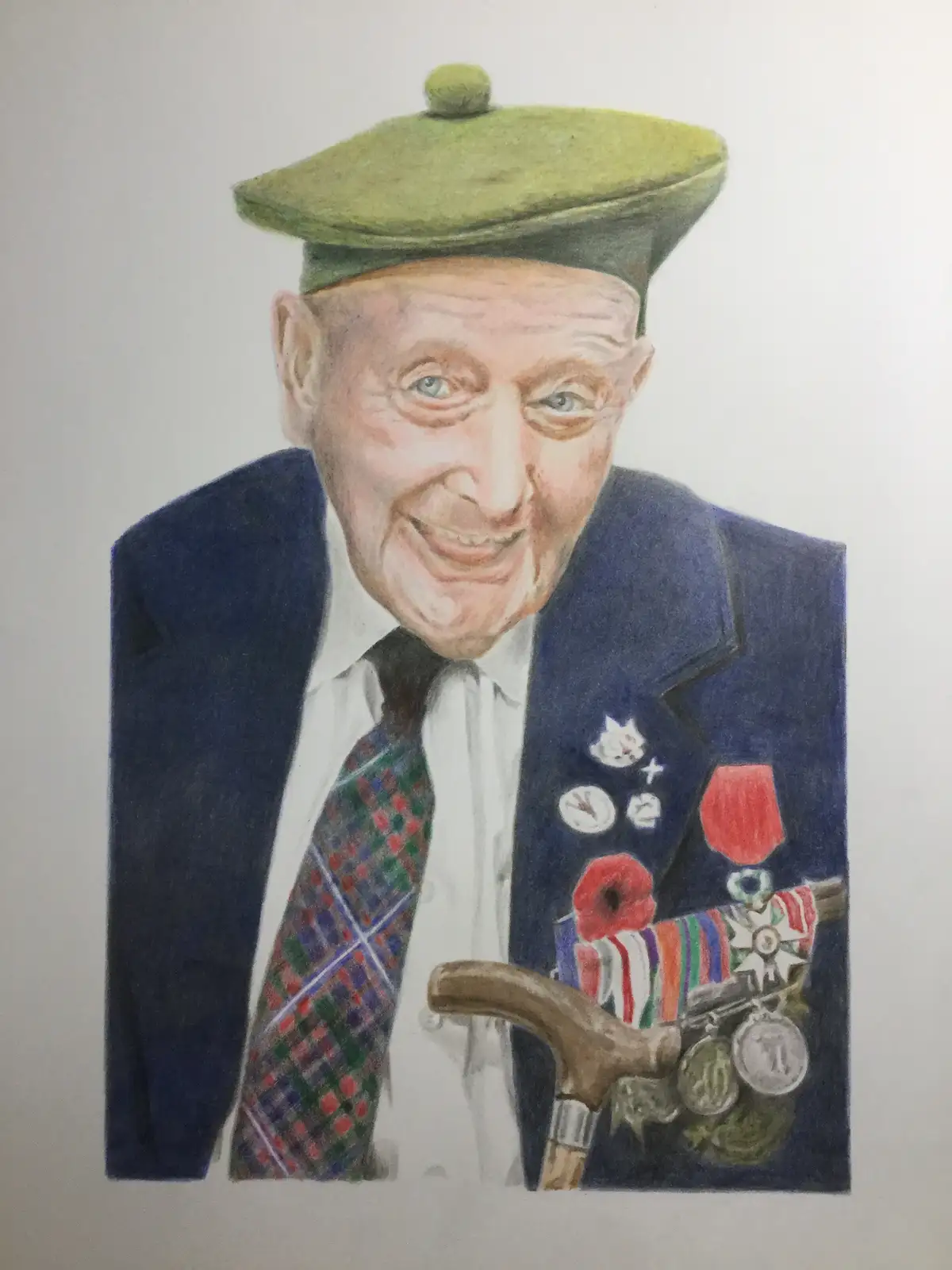 A colored pencil portrait of an elderly man with a green flat cap, blue suit, and plaid tie, smiling broadly while holding a…
