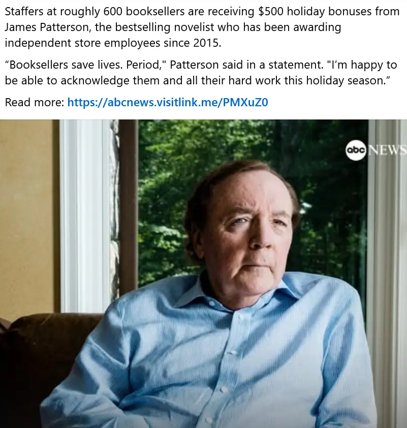 A man with a serious, slightly skeptical expression sits in a chair, wearing a light blue button-down shirt, with green…