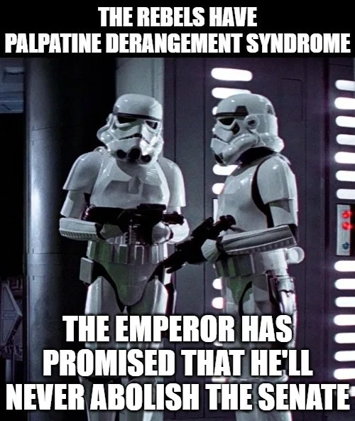 Two stormtroopers stand facing each other in a dimly lit corridor with vertical light panels on the walls. The trooper on…