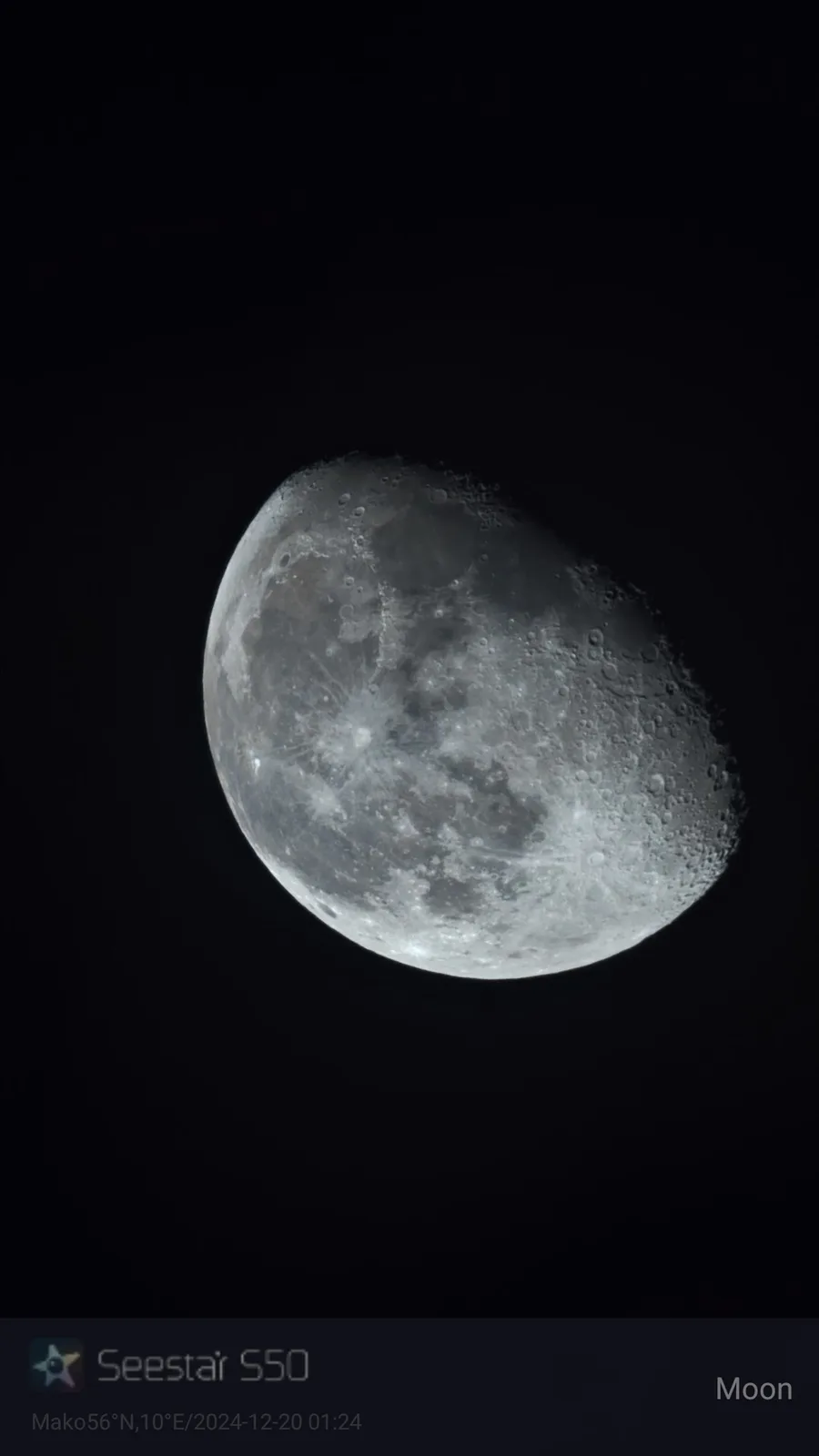 A close-up photograph of the moon against a black sky, showing its cratered surface and illuminated crescent. The image has…