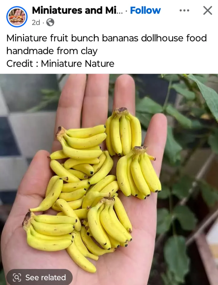A hand holds numerous tiny, yellow clay bananas arranged in small bunches, resembling real bananas but clearly miniature and…