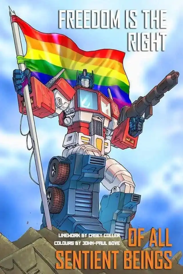 A red and blue robot, resembling Optimus Prime from Transformers, stands atop a rocky outcrop holding a rainbow flag on a…
