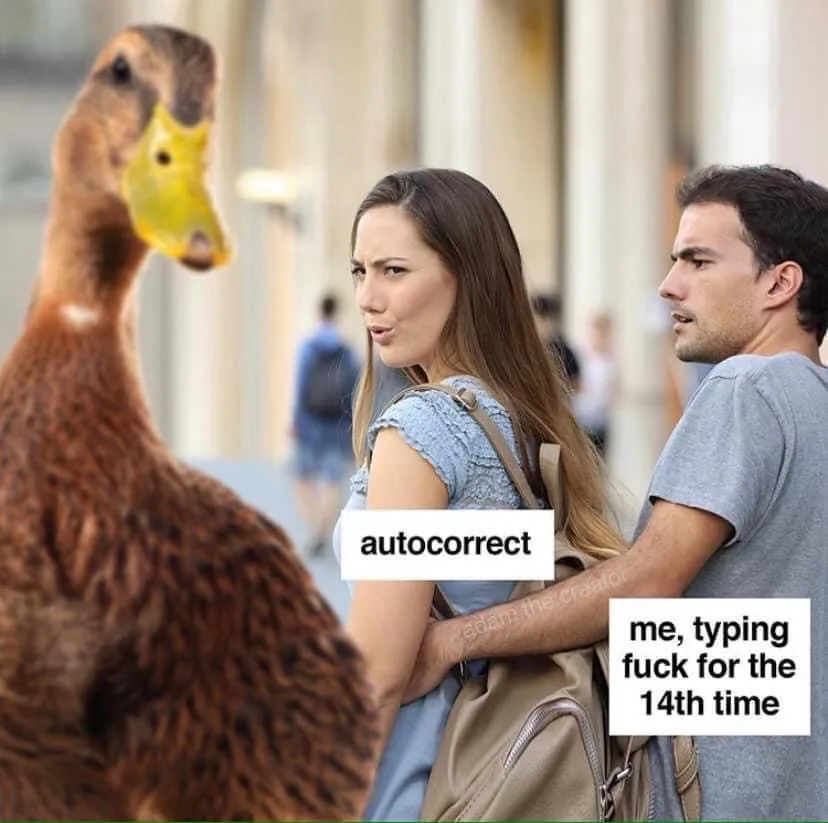 A woman and man stand together, looking annoyed at a duck. The woman has 'autocorrect' written over her, and the man has…