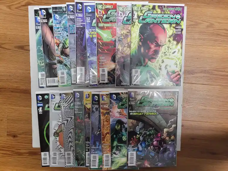 A collection of DC Comics Green Lantern issues from 'The New 52!' era, arranged in two rows on a wooden floor, featuring…