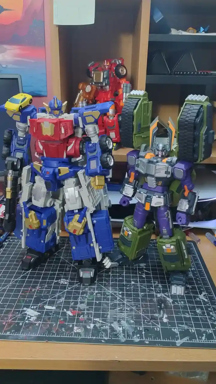 Two large, detailed Transformers action figures, Optimus Prime (blue, red, white, gold) and Megatron (purple, green, gray…