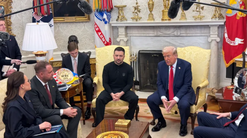 in an official-looking room with flags and ornate furniture, ukrainian president volodymyr zelenskyy sits in a yellow chair…