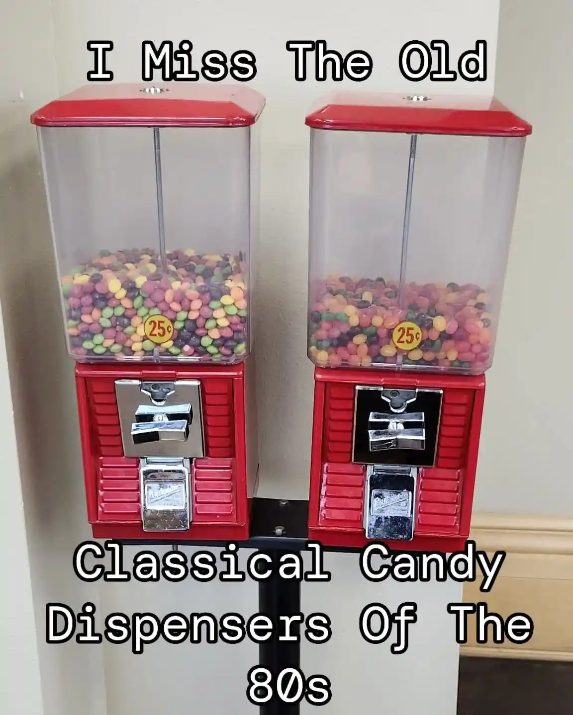 Two red, vintage-style gumball machines filled with colorful candies are mounted side-by-side on a stand. Each machine has a…