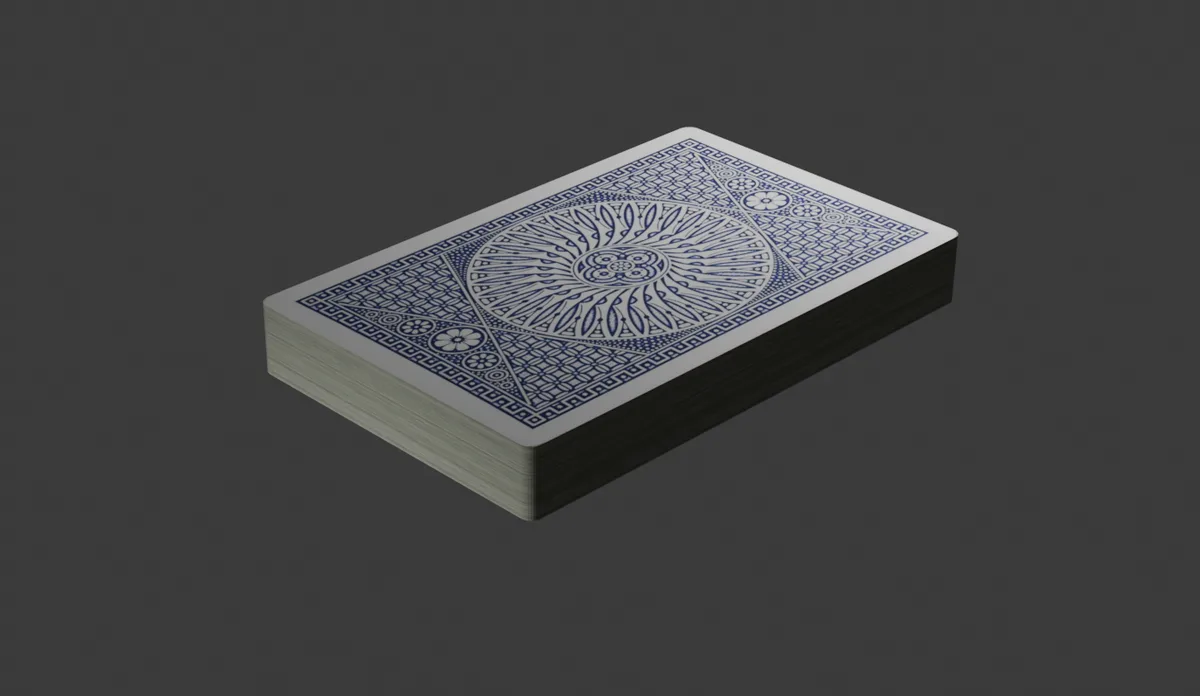 A neatly stacked deck of playing cards with a classic blue and white back design, shown at an angle against a plain dark…
