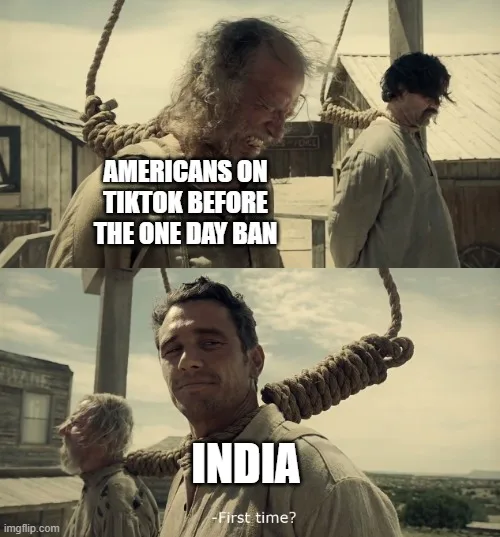 The image is a two-panel meme using a scene from a Western movie where two men are hanging from nooses. In the top panel, a…