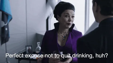A woman in a purple outfit holds a glass while speaking to a man in a dark uniform. The scene is repeated in three panels…