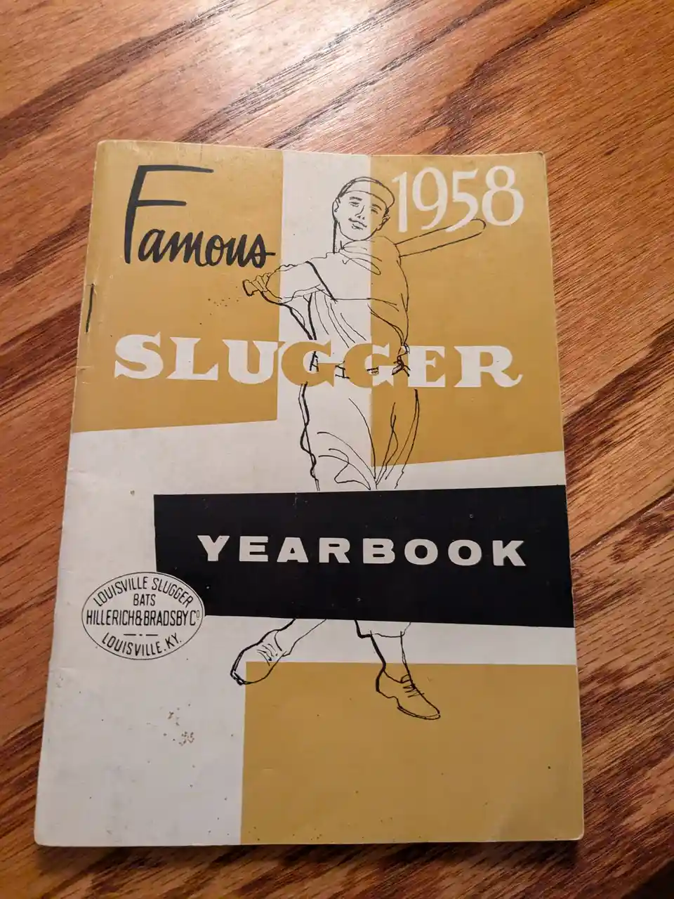 A vintage 1958 'Famous Slugger Yearbook' cover featuring a black-and-white line drawing of a baseball player mid-swing, set…