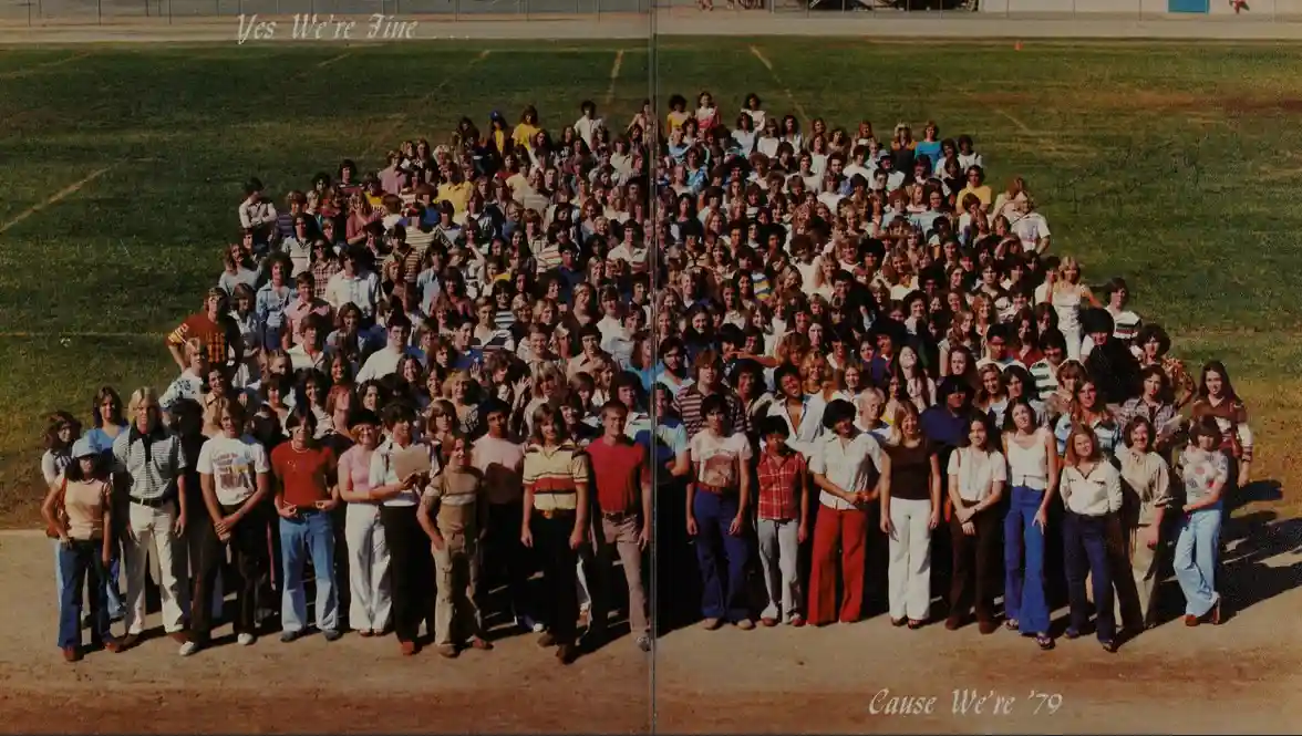 A vintage, split-screen school photo of a large group of students from the 1970s arranged in rows on a grassy field, with…