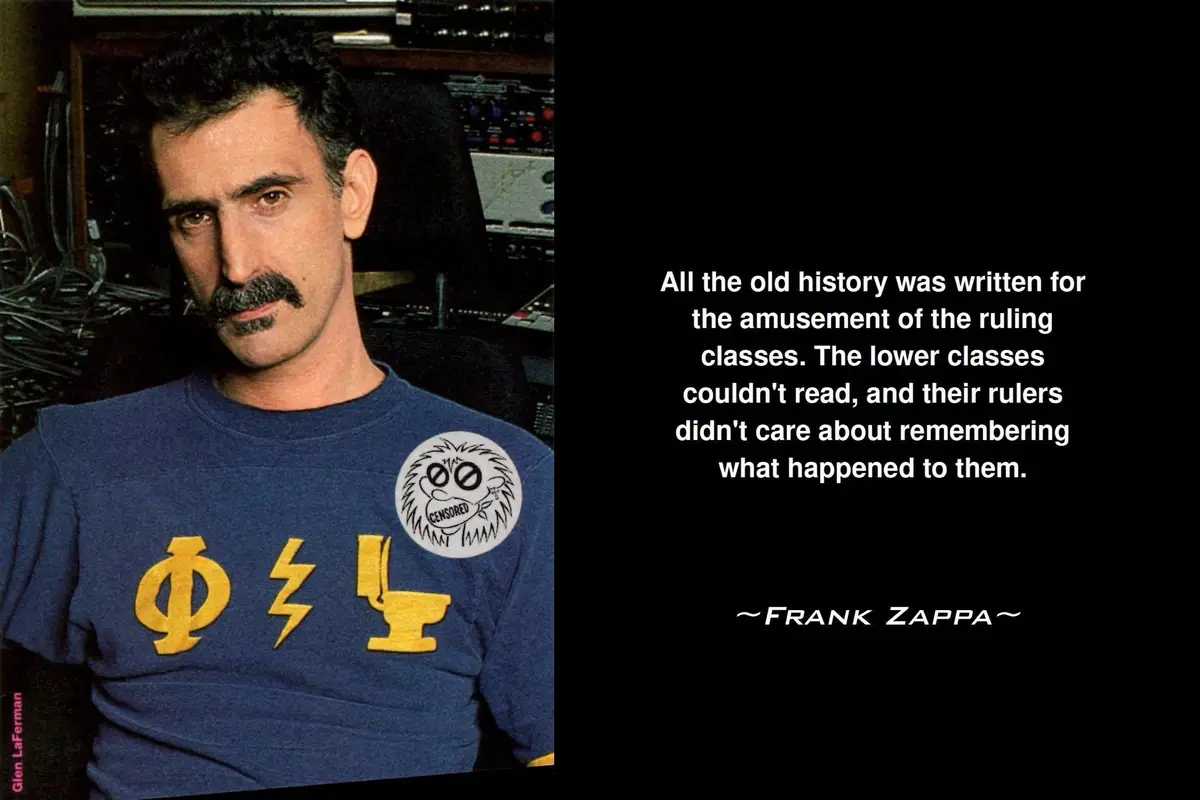 A photo of Frank Zappa wearing a blue t-shirt with yellow symbols and a 'CENSORED' patch, set against a dark background with…