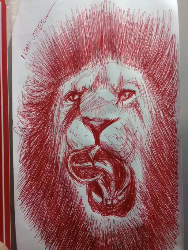 A hand-drawn sketch in red ink on white paper depicts a lion's head with a fierce, roaring expression, its mane rendered…