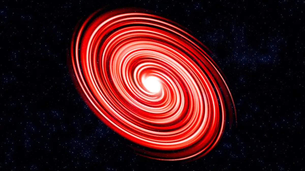 A cosmic image shows a swirling red spiral galaxy or accretion disk against a starry black background, with the overlaid…