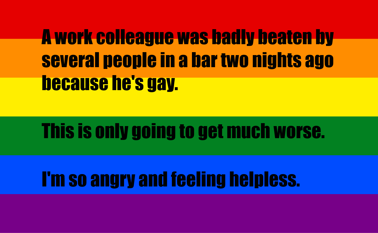 The image displays a rainbow flag with black text overlaid in three sections. The top section reads 'A work colleague was…