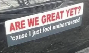 A close-up of a car bumper sticker with red text asking 'ARE WE GREAT YET?' and smaller black text below reading ''cause I…