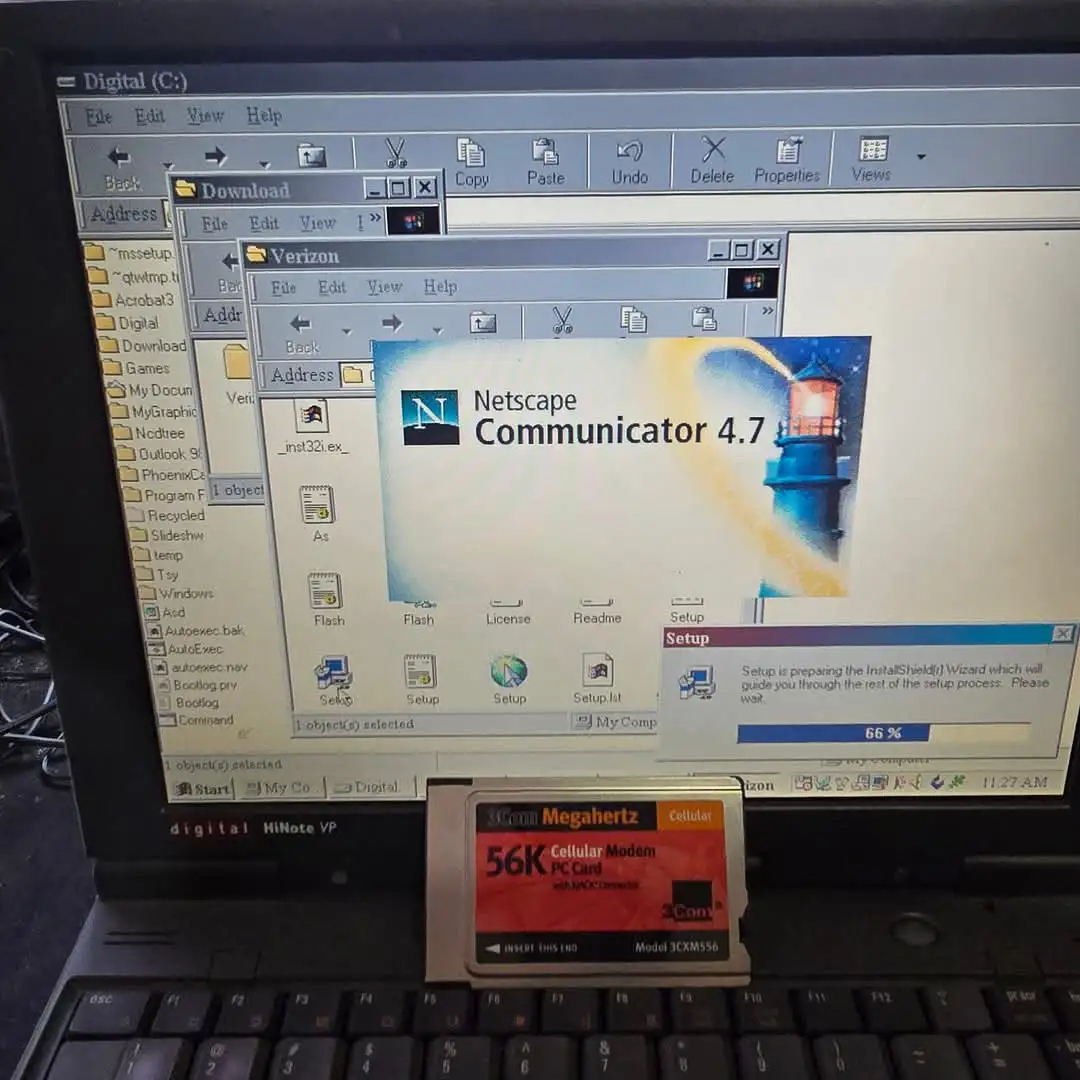 A photo of an old laptop screen showing the Netscape Communicator 4.7 setup window at 66% completion, with a 3Com 56K…
