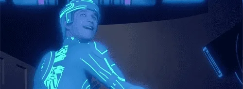 The image shows a sequence of six panels from the movie Tron: Legacy, featuring the character Quorra in her glowing blue…