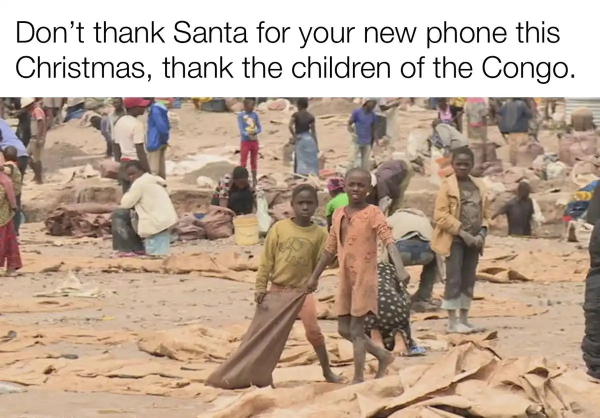 The image shows several children, some barefoot and wearing worn clothing, walking through a muddy, debris-strewn area with…