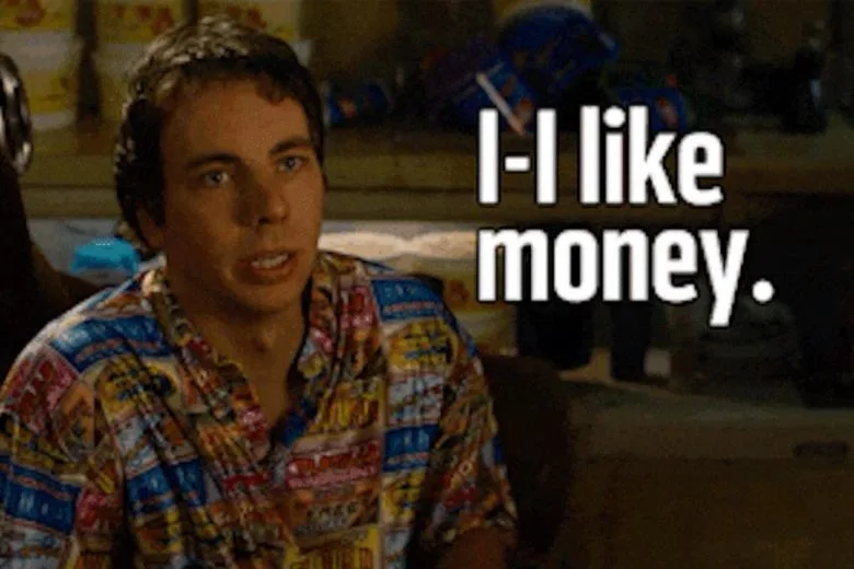 A still image of a man with wide eyes and a slightly open mouth, wearing a colorful, patterned shirt, looking surprised or…