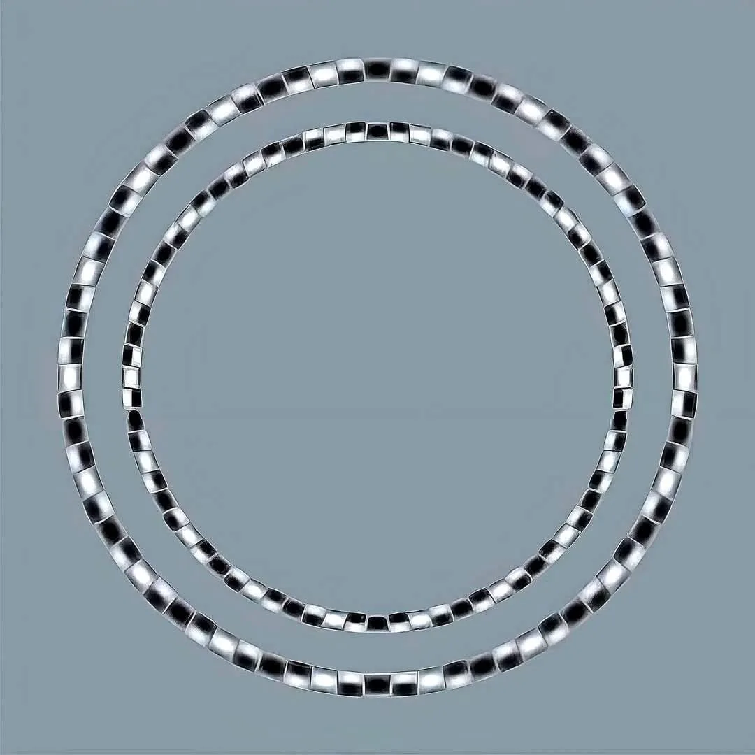 Two concentric silver beaded chains form perfect circles against a plain gray background. The overlaid text reads 'i'm not…
