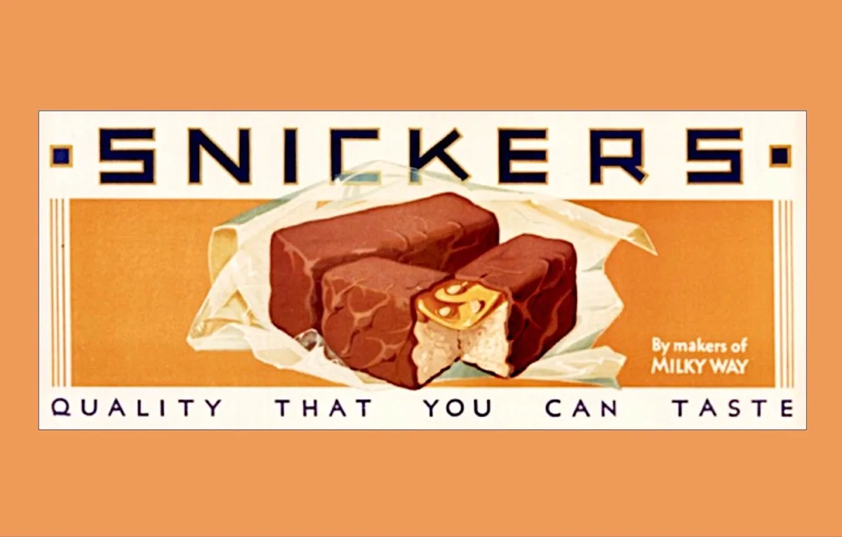A vintage-style Snickers chocolate bar advertisement shows two bars, one whole and one broken to reveal the caramel, nougat…