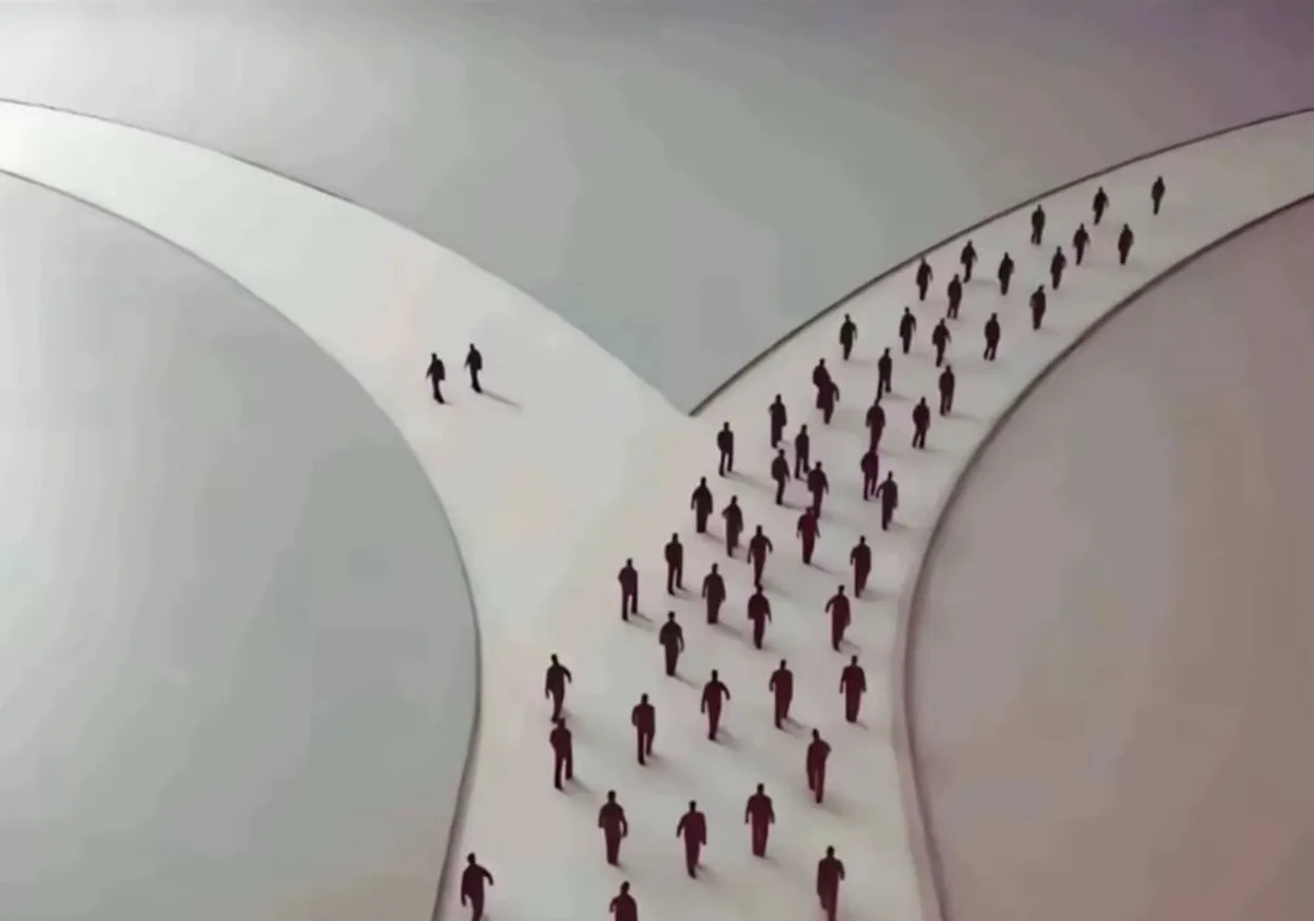 An overhead view of stylized human figures walking along three diverging paths; a large group follows the central, crowded…