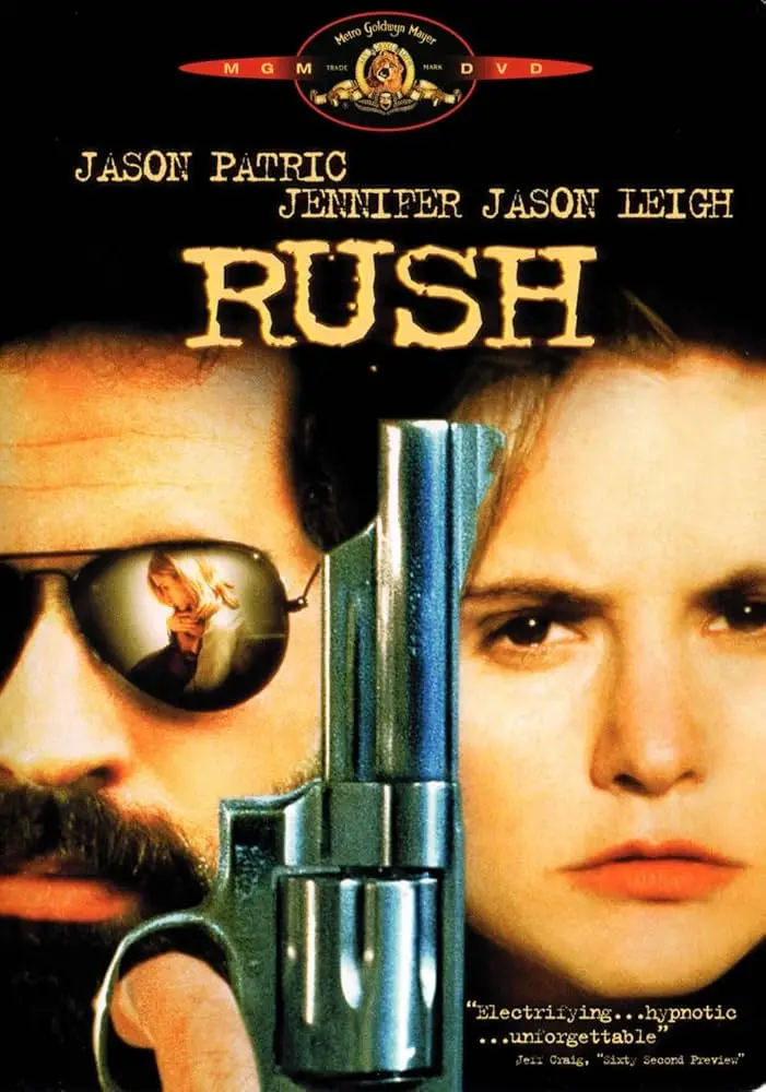 A movie poster for the film 'Rush' starring Jason Patric and Jennifer Jason Leigh, showing a man with a mustache holding a…