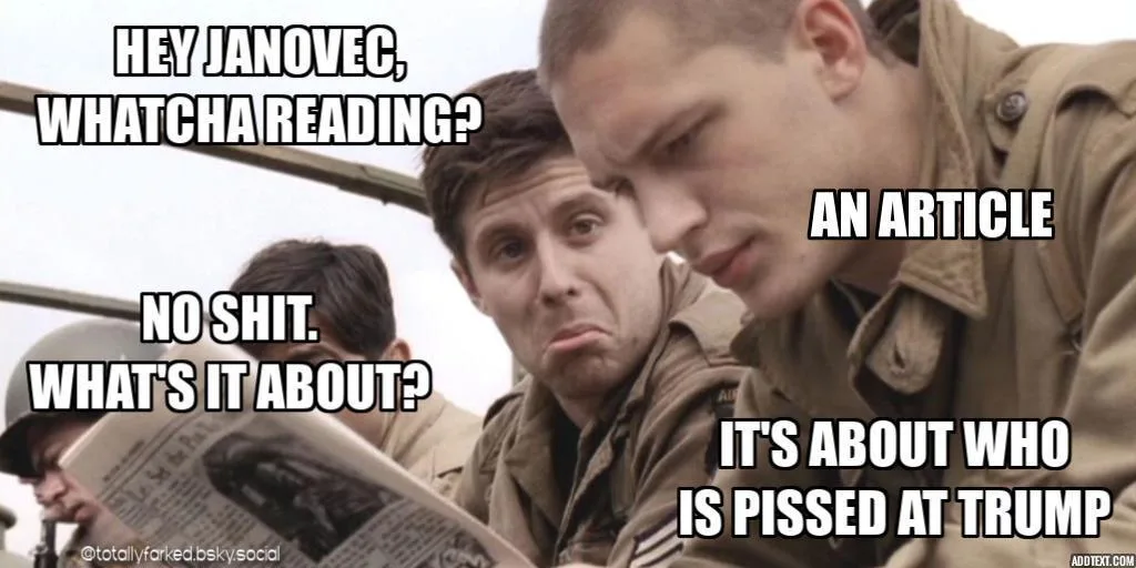 A still from a movie shows two soldiers in uniform, one holding a newspaper and looking surprised, the other leaning in with…