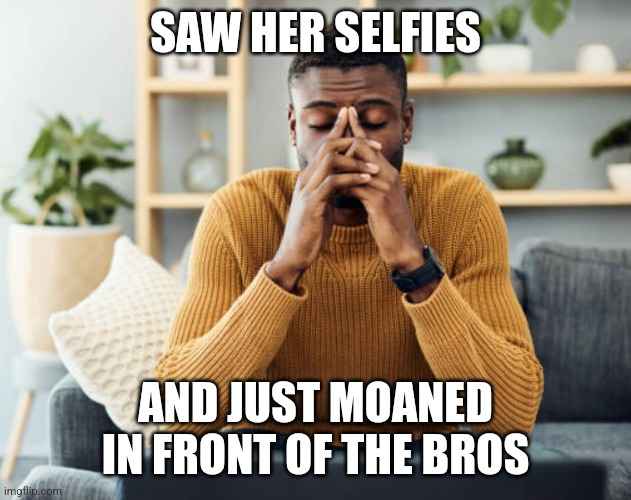 A man in a mustard yellow sweater sits on a couch with his eyes closed and hands covering his face, conveying distress or…
