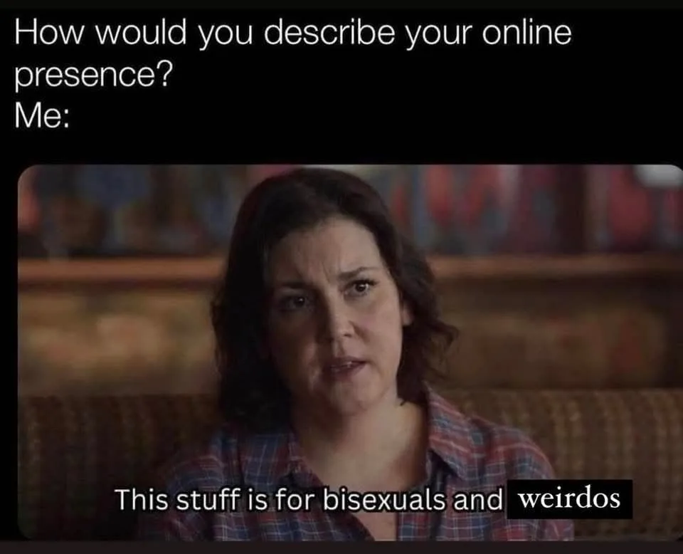 A woman with dark hair and a plaid shirt looks directly at the camera with a slightly confused or resigned expression. The…