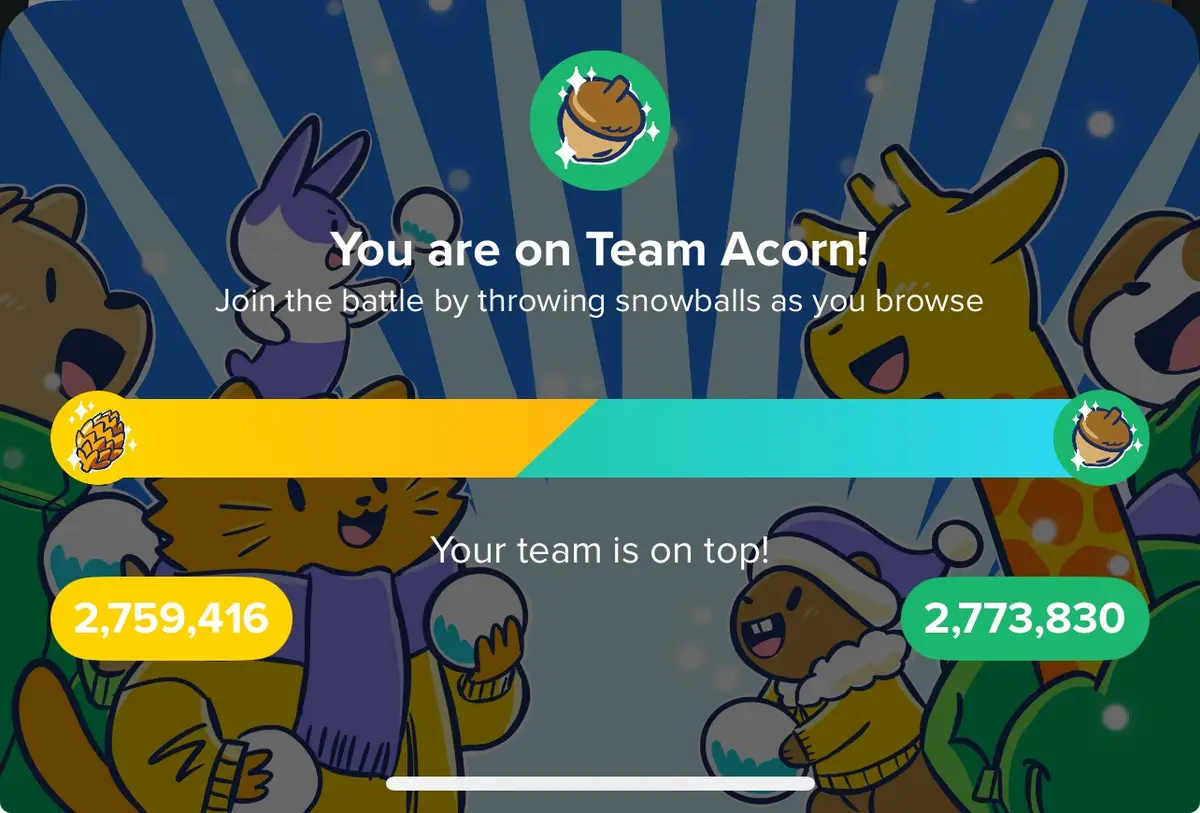 An image from the 'Snowball Fight' feature in the 'Acorn' app, showing a scoreboard with two teams: 'Team Acorn' (yellow…