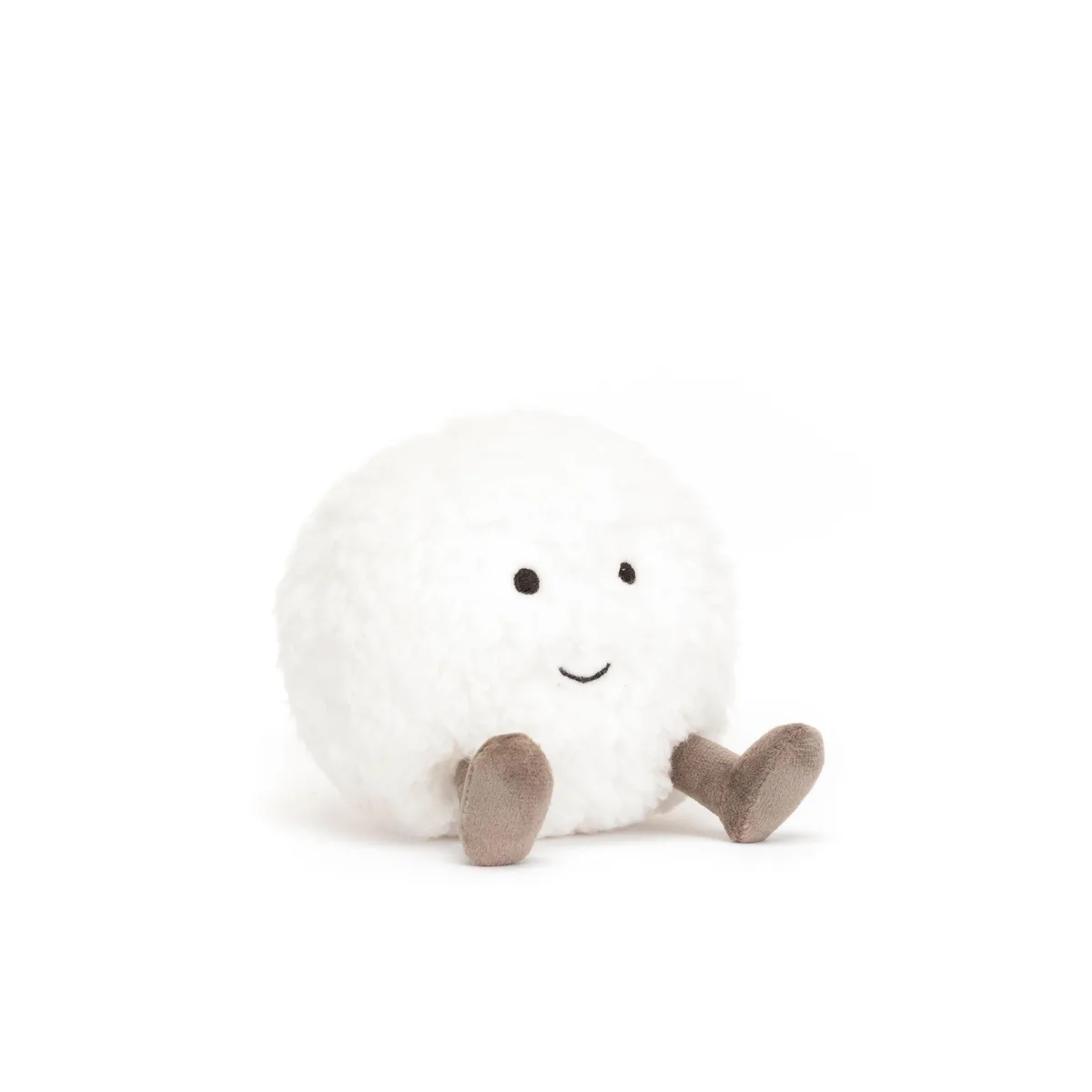 A fluffy white plush toy with a simple smiling face and short brown legs sits cross-legged against a plain white background…