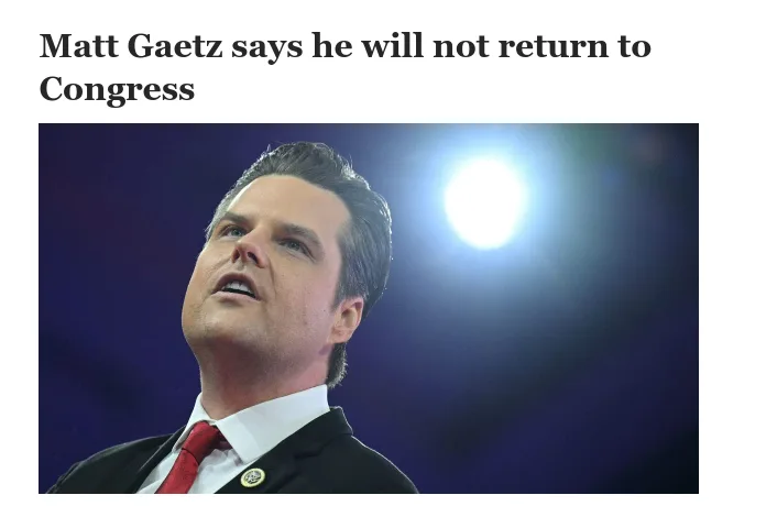 A man in a dark suit, white shirt, and red tie looks upward with his mouth slightly open, as if speaking or reacting. A…