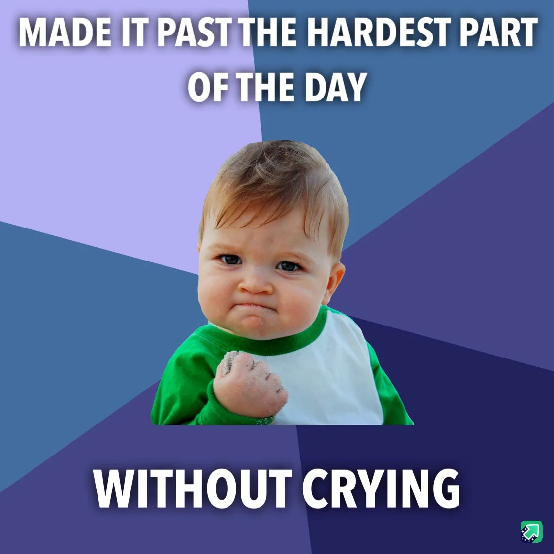A baby with a determined, slightly pouty expression, wearing a green and white shirt, clenches a fist covered in sand. The…
